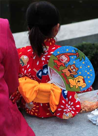 Little Girl in Japanese Costume on Bench