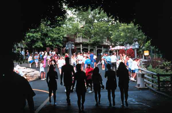 People Silhouetted in Arch Walkway